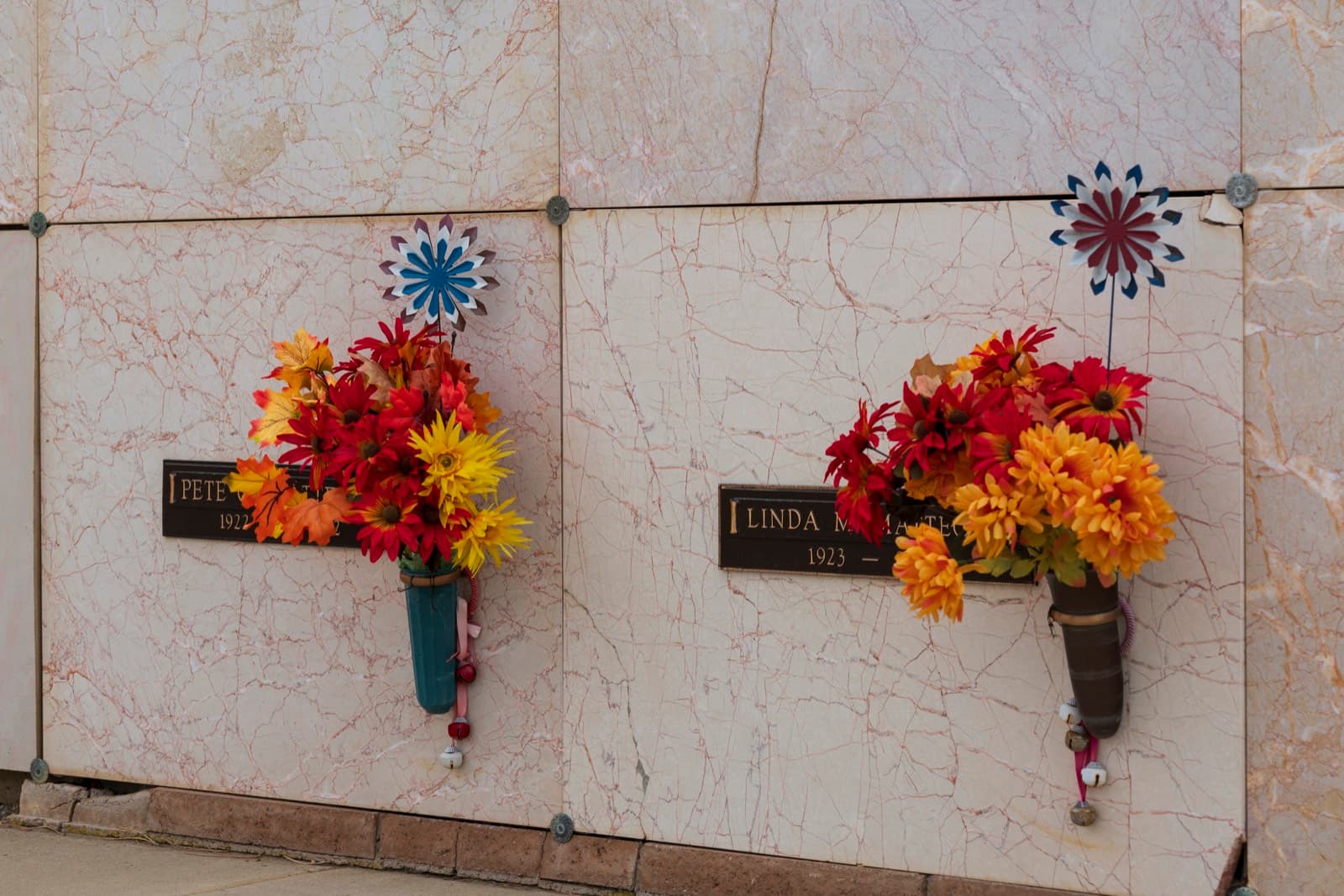 Fresh flowers along a marble niche wall